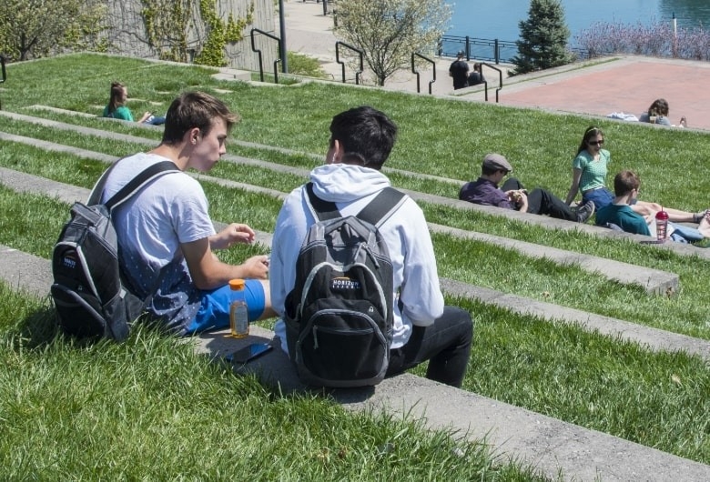 Students sitting outdoors on NKU's campus.
