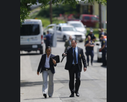 Dave Johnston walking down street in  front of crime scene