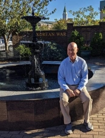 Keith Bales in front of fountain