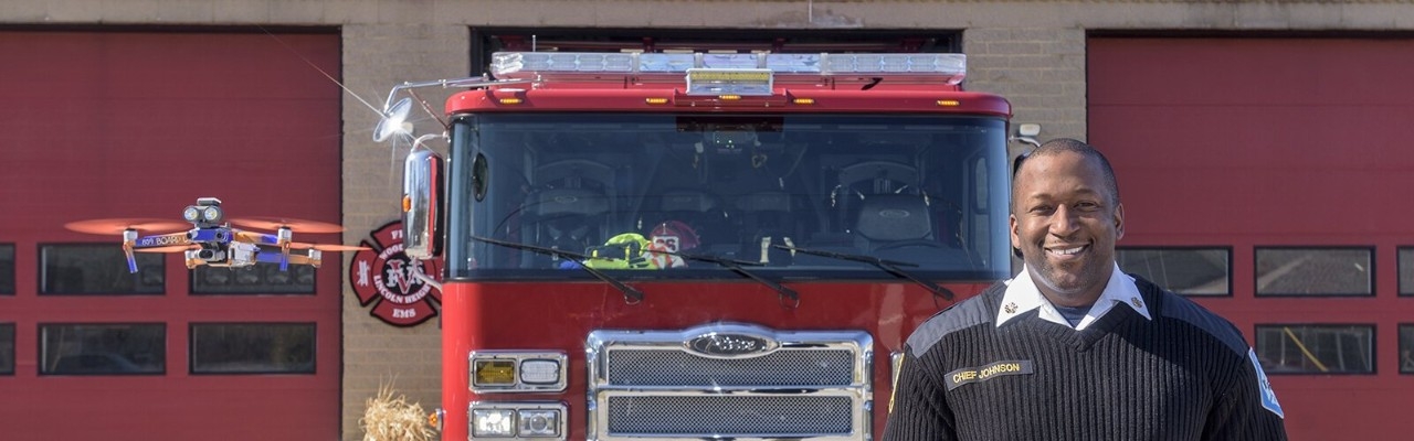 firefighter in front of fire truck