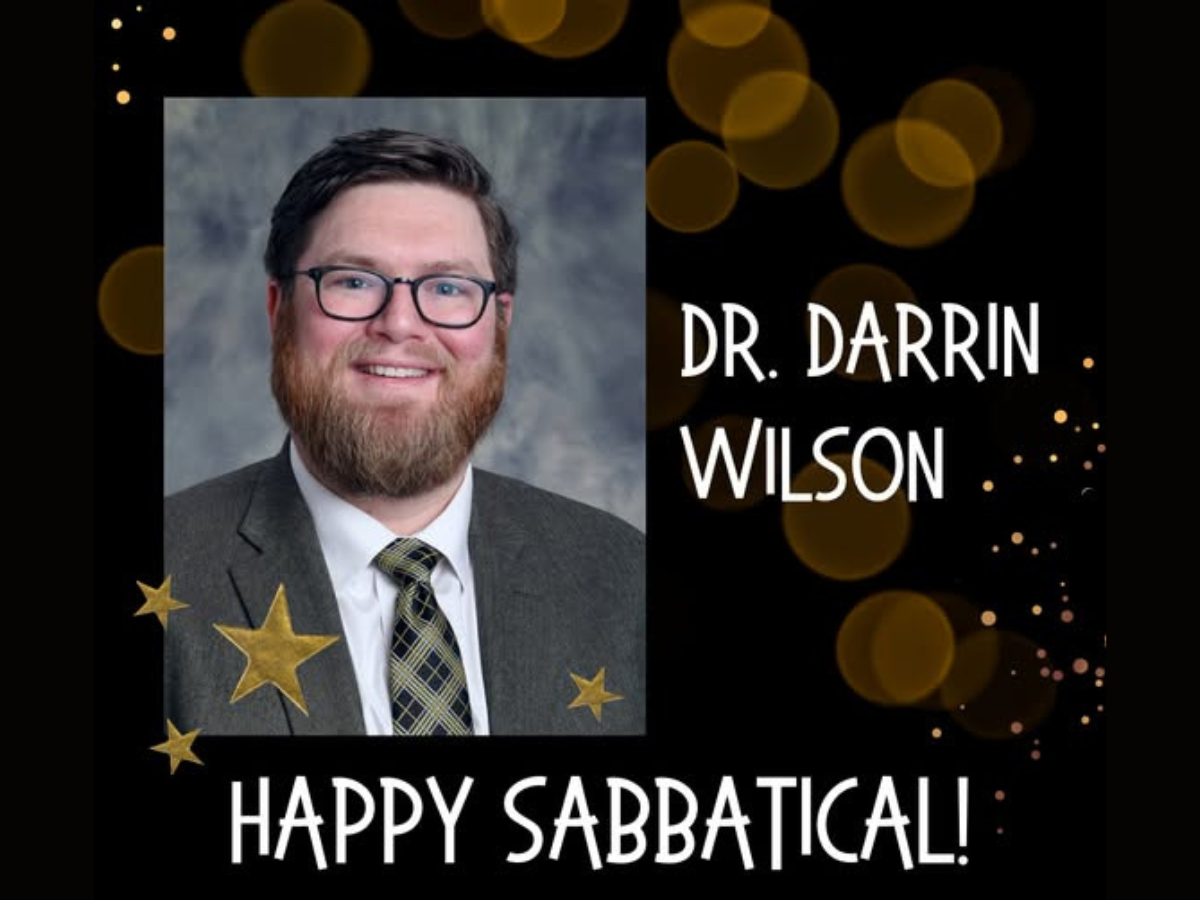 Dr. Darrin Wilson headshot with a "Happy Sabbatical" message