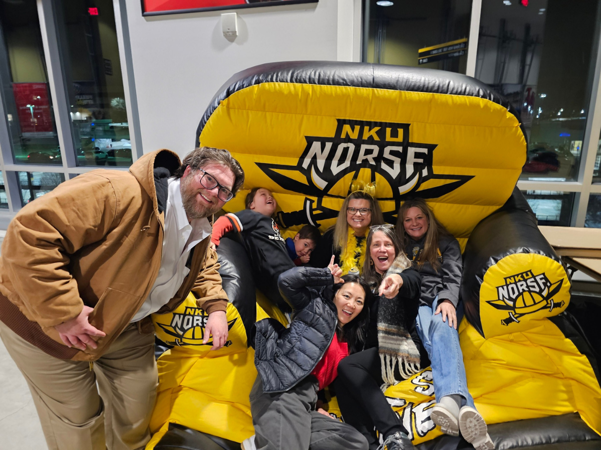 group of MPA folks sitting in an oversized NKU blow up chair