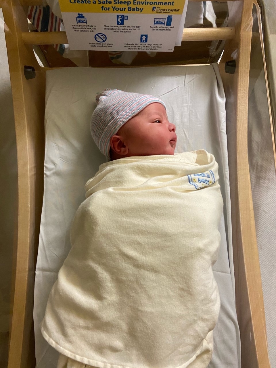 Dr. Wilson's new baby - Adrian - wrapped in blanket in bassinet