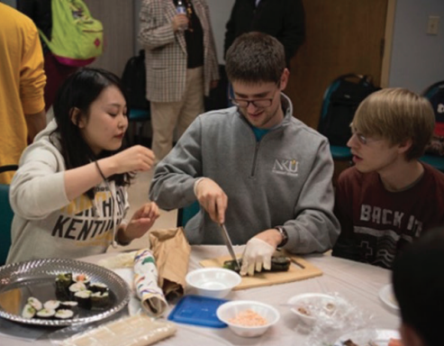 Students making sushi and dumplings 