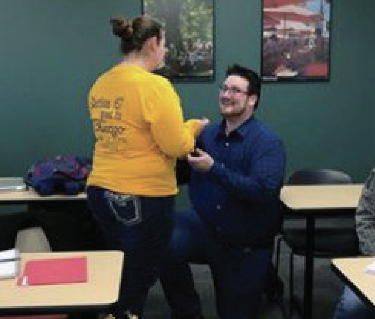 Sam Ivers proposing to Katherine Herbort in classroom