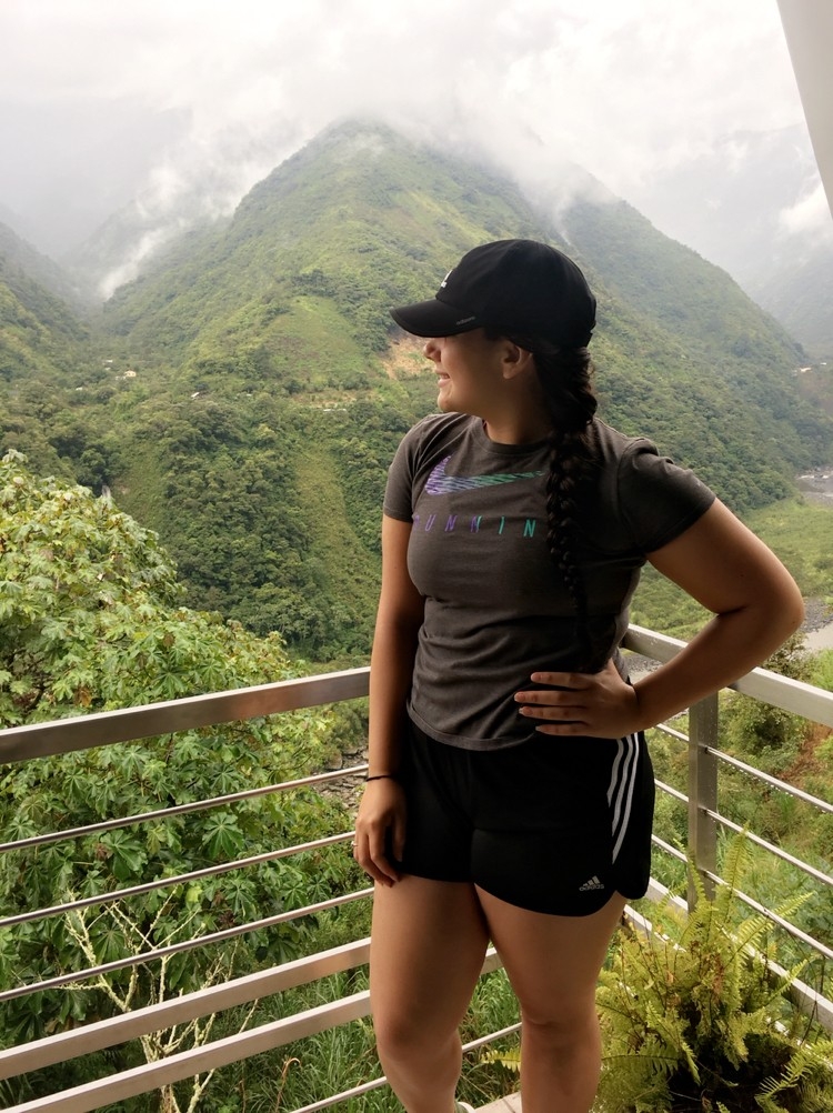 Student posting by a mountain in Ecuador