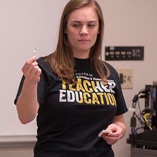 Female student teaching in a classroom