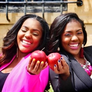 Maya and Mariah Manson, NKU alumnae, holding apples