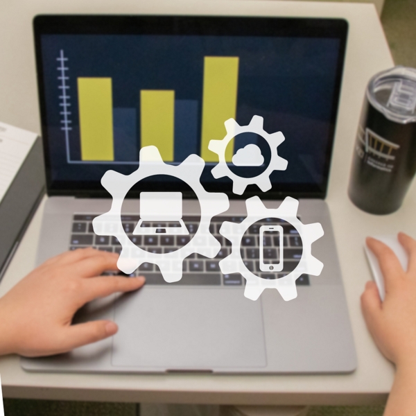 A MacBook computer with three gears representing informatics.