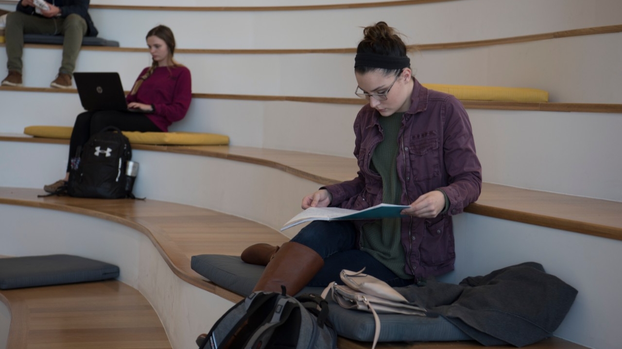 Student studying on steps in Griffin Hall