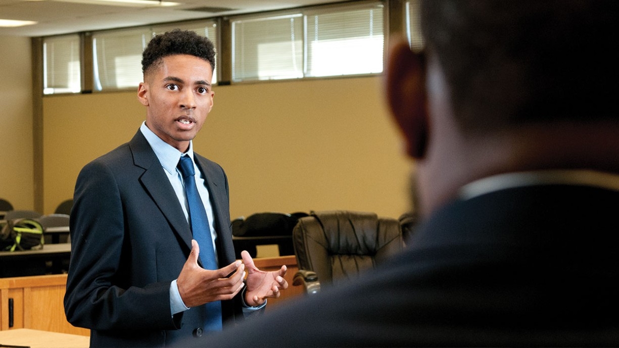 Black male law student cross examining a witness on the stand