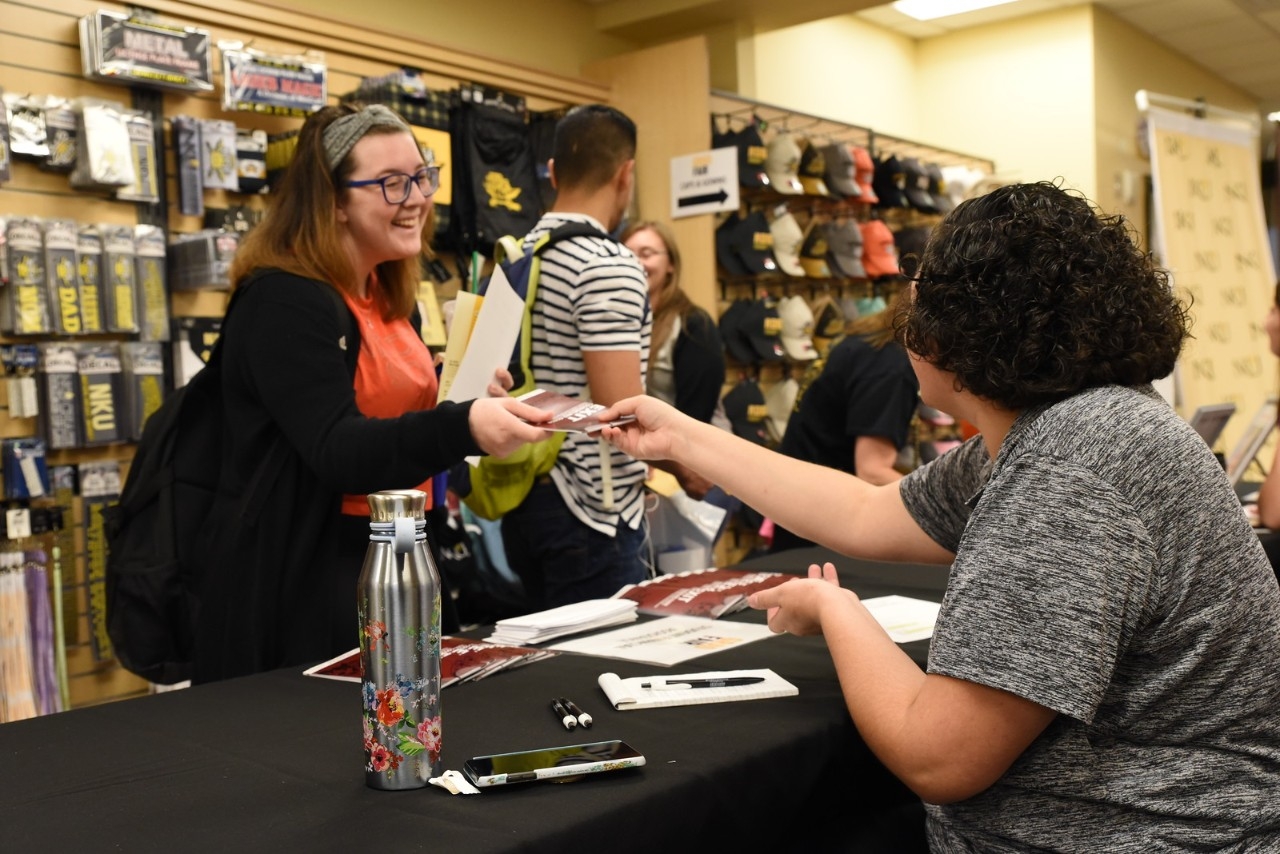 Student attending a fair hosted by the NKU Bookstore.