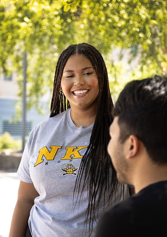Shop NKU: Students smiling wearing NKU gear