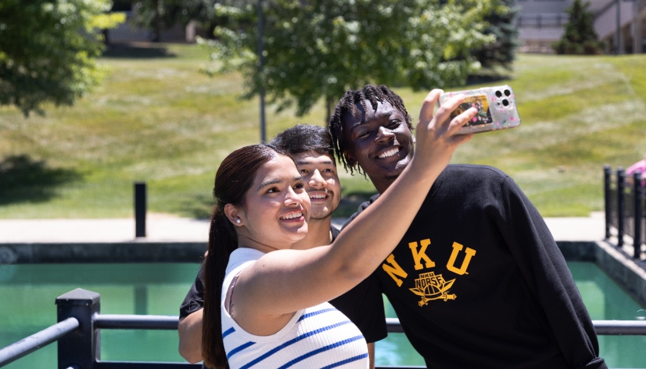 Three students taking a selfie out by Loch Norse.