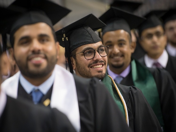 Graduating students at cap and gown ceremony