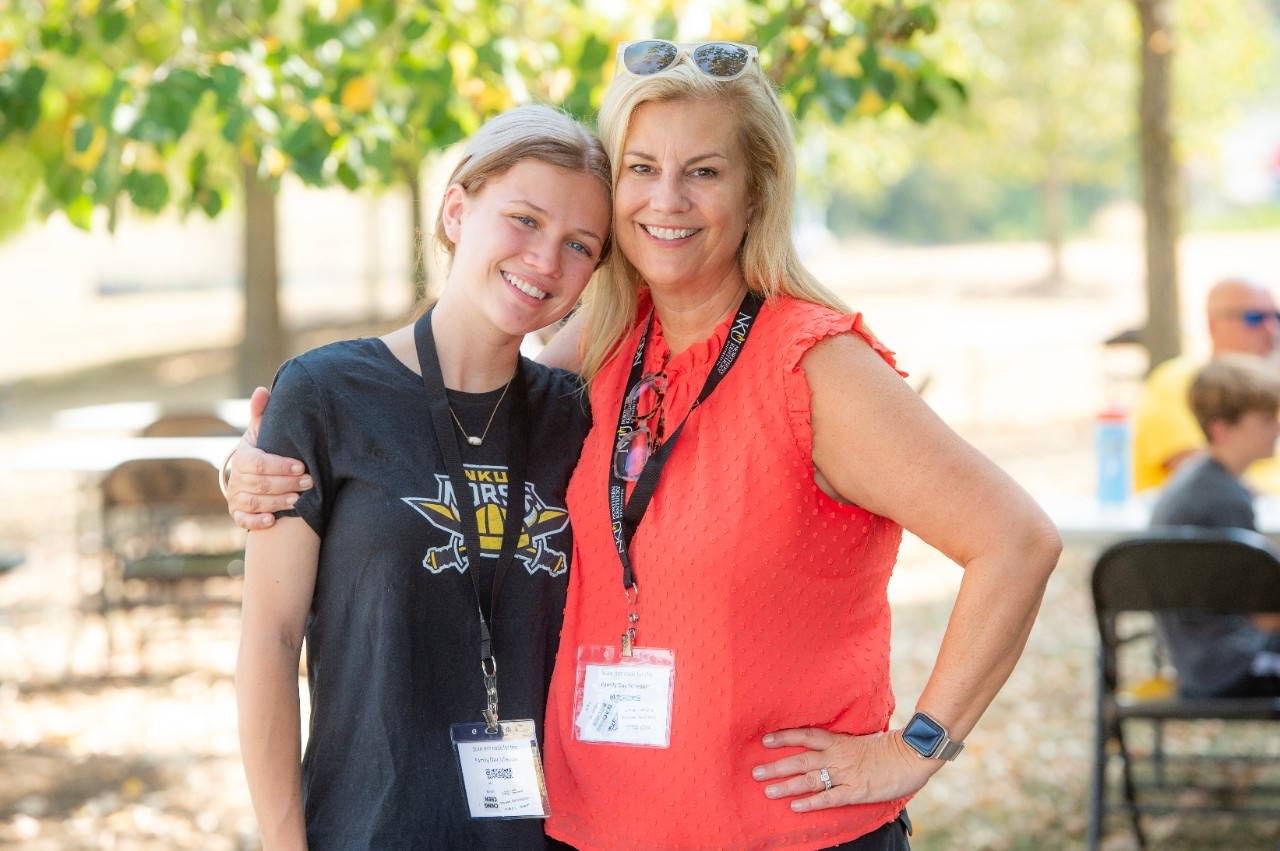 Mother and daughter posing together at Family Day