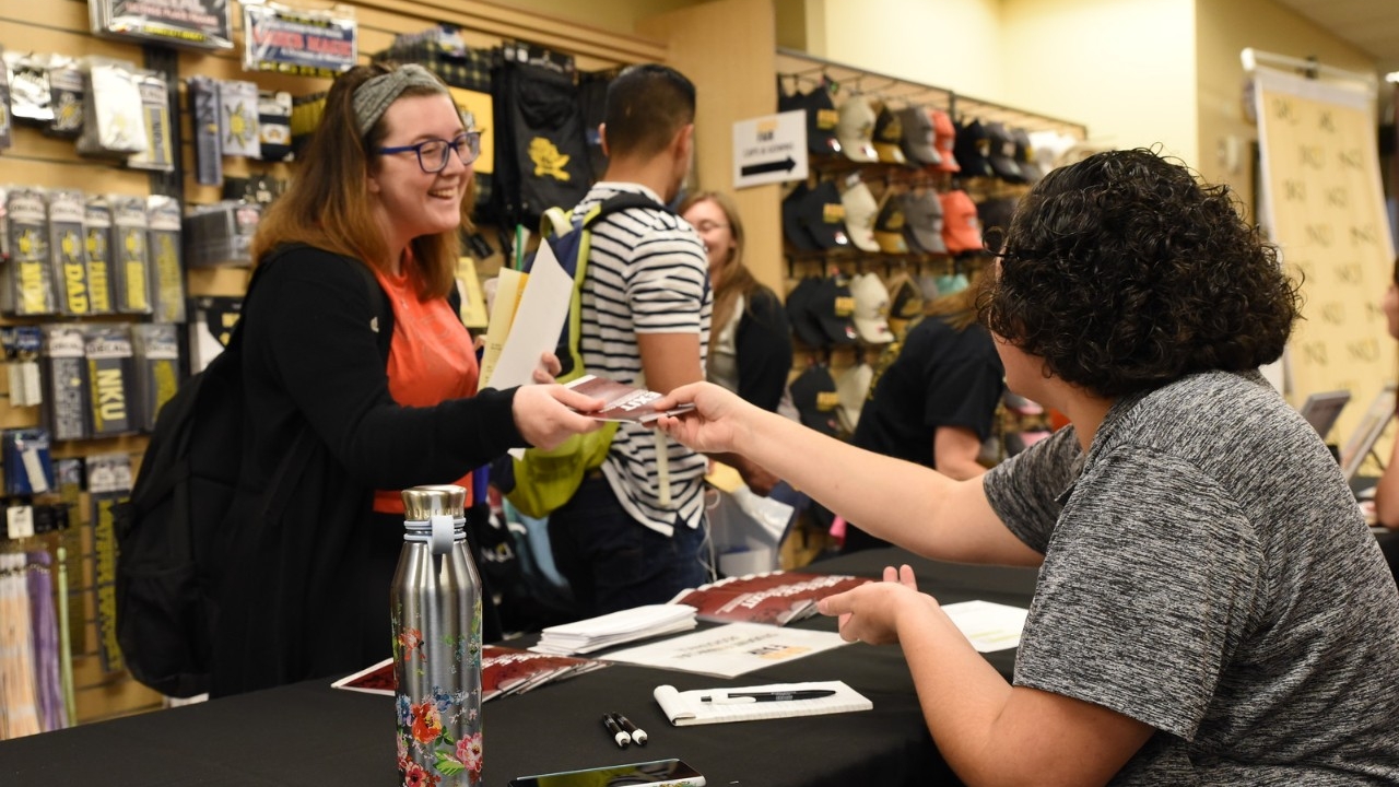 A student makes a purchase at the NKU bookstore