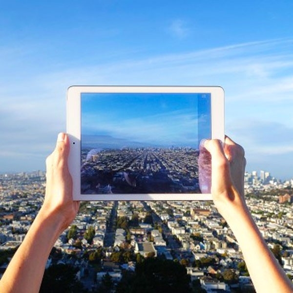 Taking photography with an iPad of a cityscape.