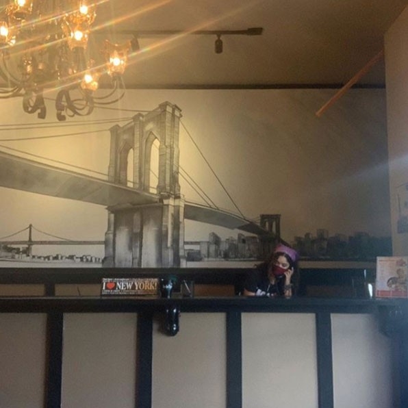 Humans of Greater Cincinnati Post: A woman behind a counter at a cafe working. 