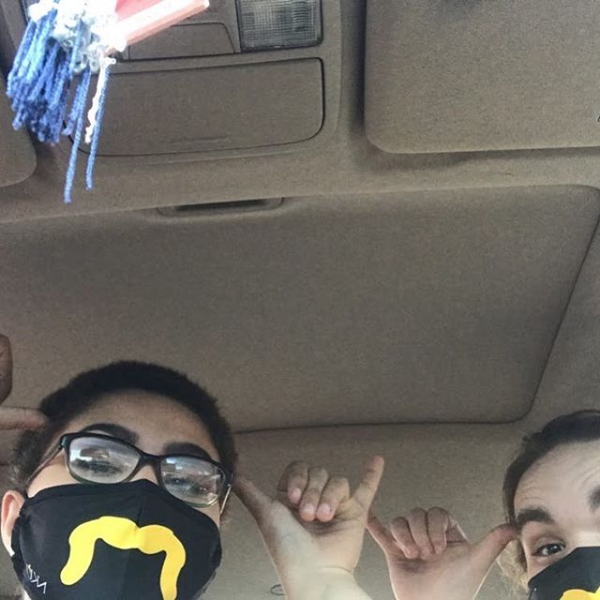 Humans of Greater Cincinnati Post:two people in a car doing the "norse up" sign