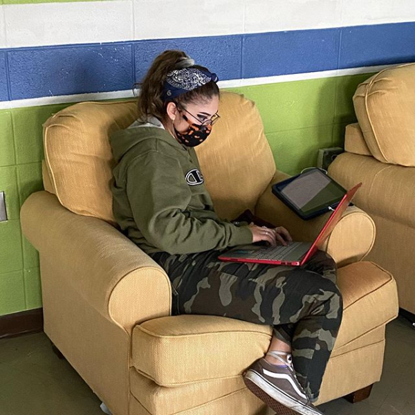 Humans of Greater Cincinnati Post: female student wearing mask and working on laptop