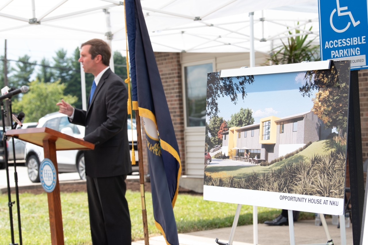 Governor Andy Beshear presents a $1 million check to the Brighton Center for the development of the Opportunity House.