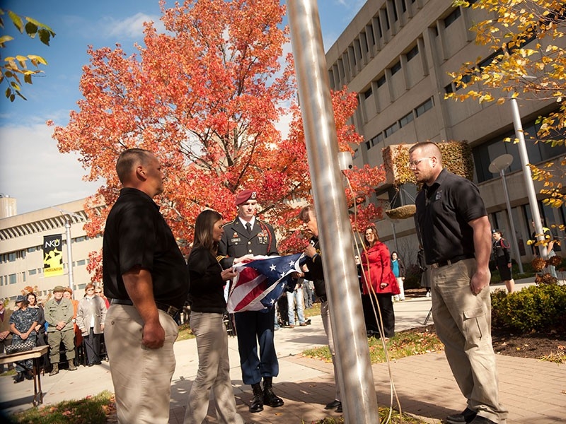 Students participating in flag ceremony at flag pole at NKU