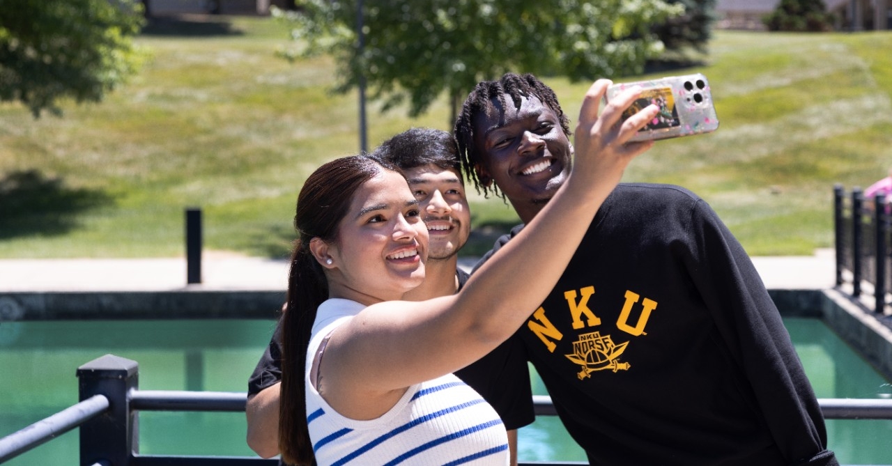 Three students taking a selfie by Loch Norse