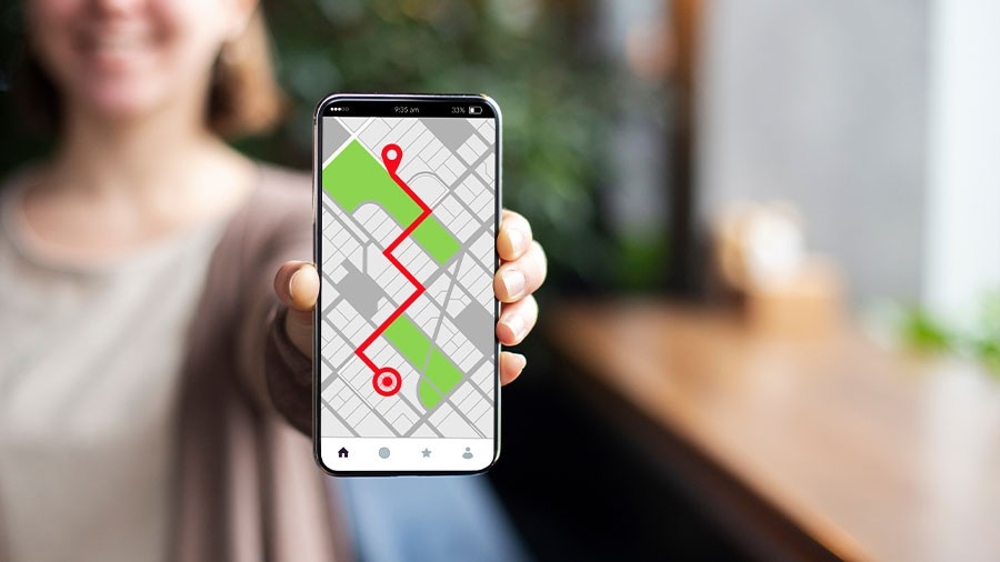 Woman holding smartphone with map image on it