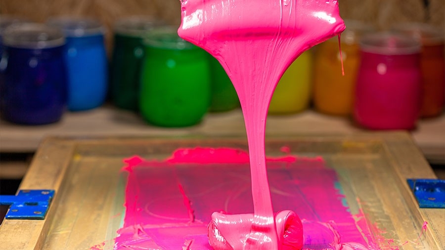 pink color dripping from hand screen printing during printing tee shirt