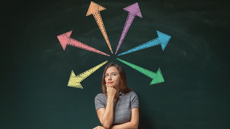 Concept of decision making - a woman surrounded by arrows of different colors