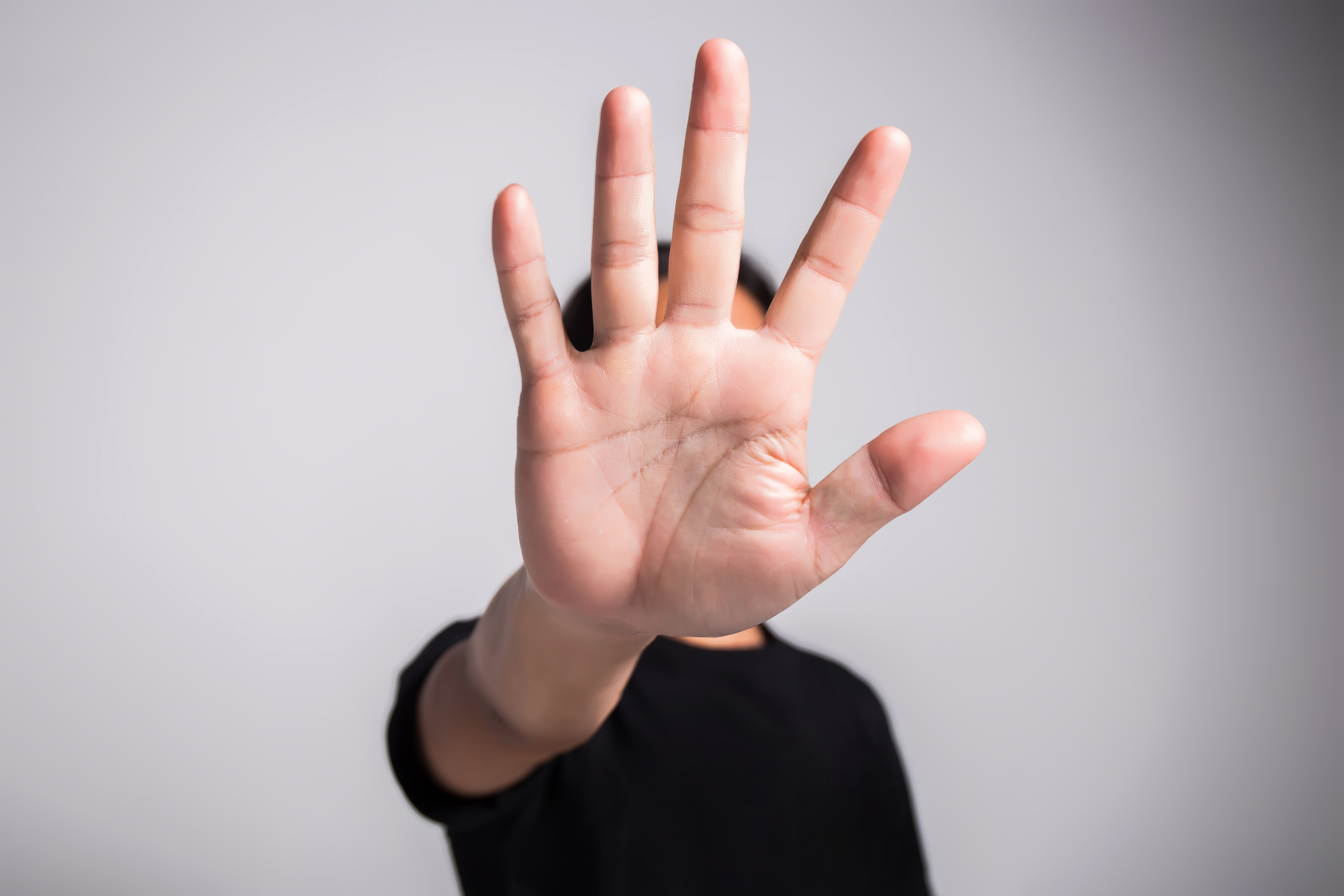 Hand held up indicating stop
