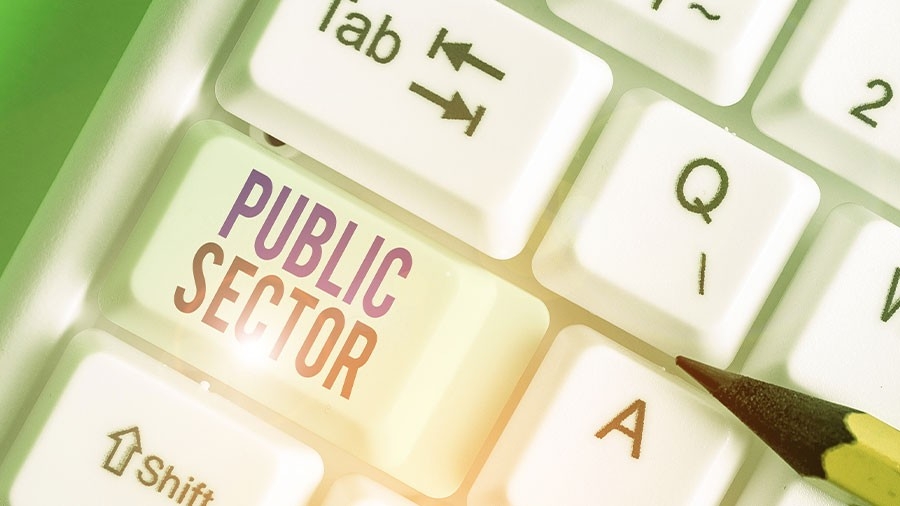 A pencil on a computer keyboard with the words "Public Sector" on one of the keys