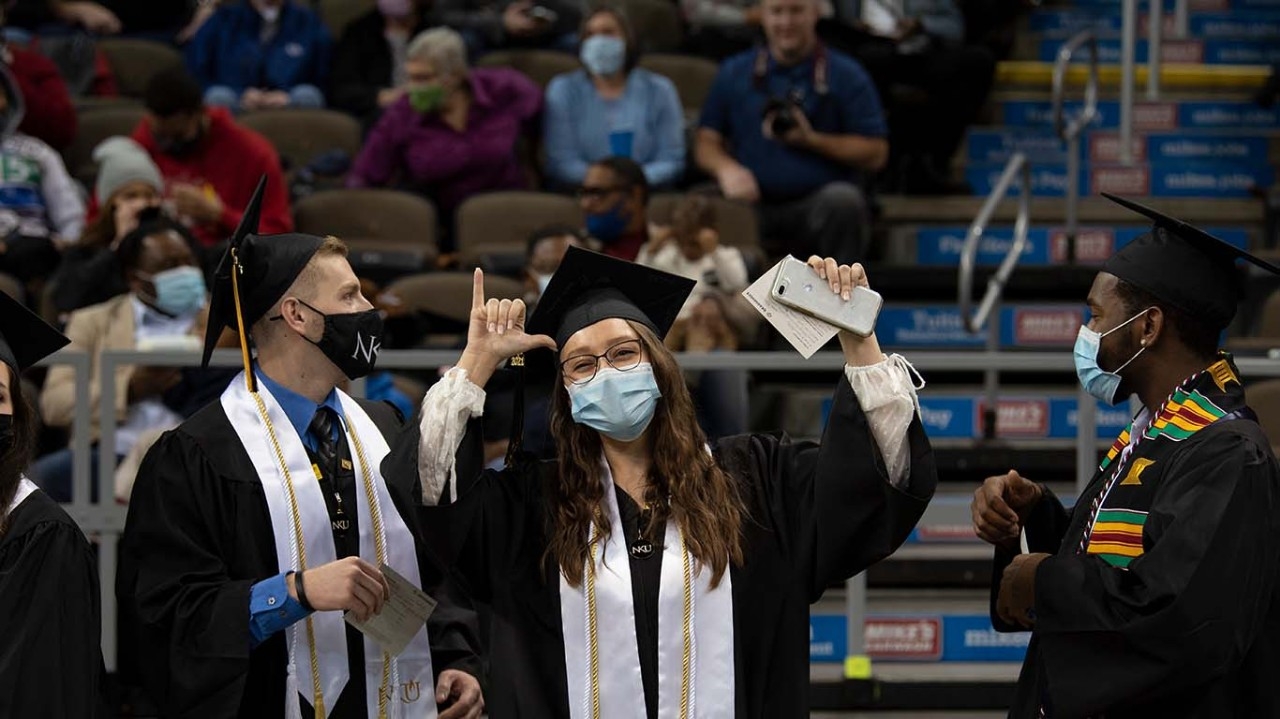 Student throws Norse Up during NKU Fall 2021 Commencement Morning Ceremony