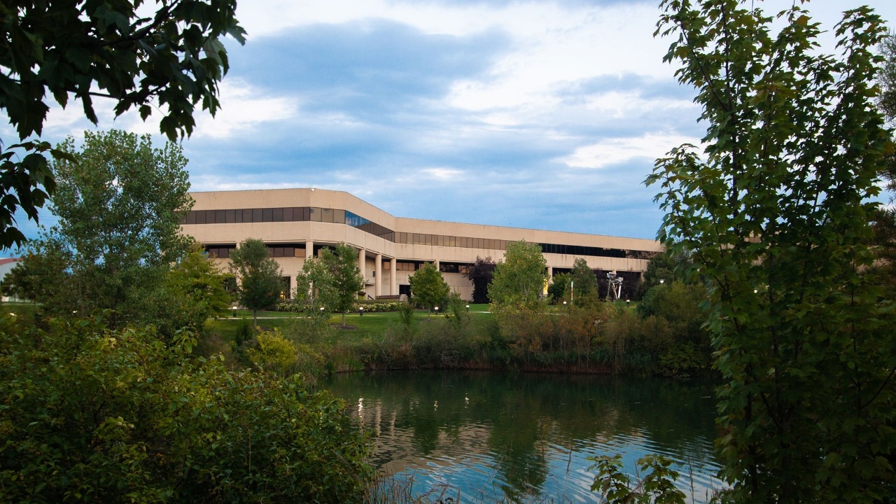 NKU's COB building in the summer with green landscaping framing image and Loch Nose in the foreground