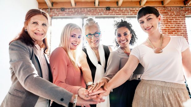 Team of businesswomen stacking hands