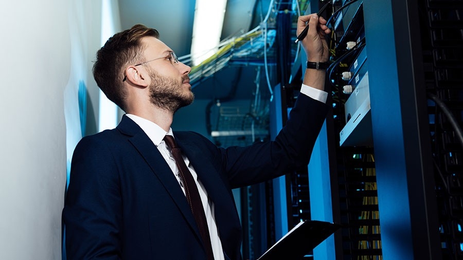 A technician examines a network server