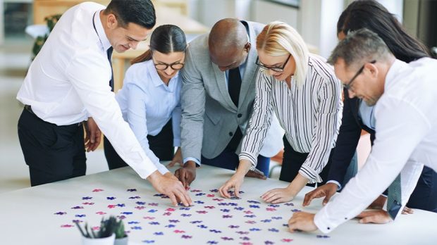 businesspeople solving a puzzle in an office