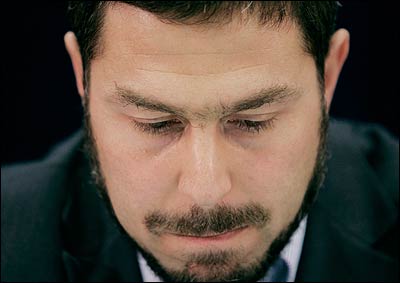 Maher Arar pauses during a news conference in Ottawa.